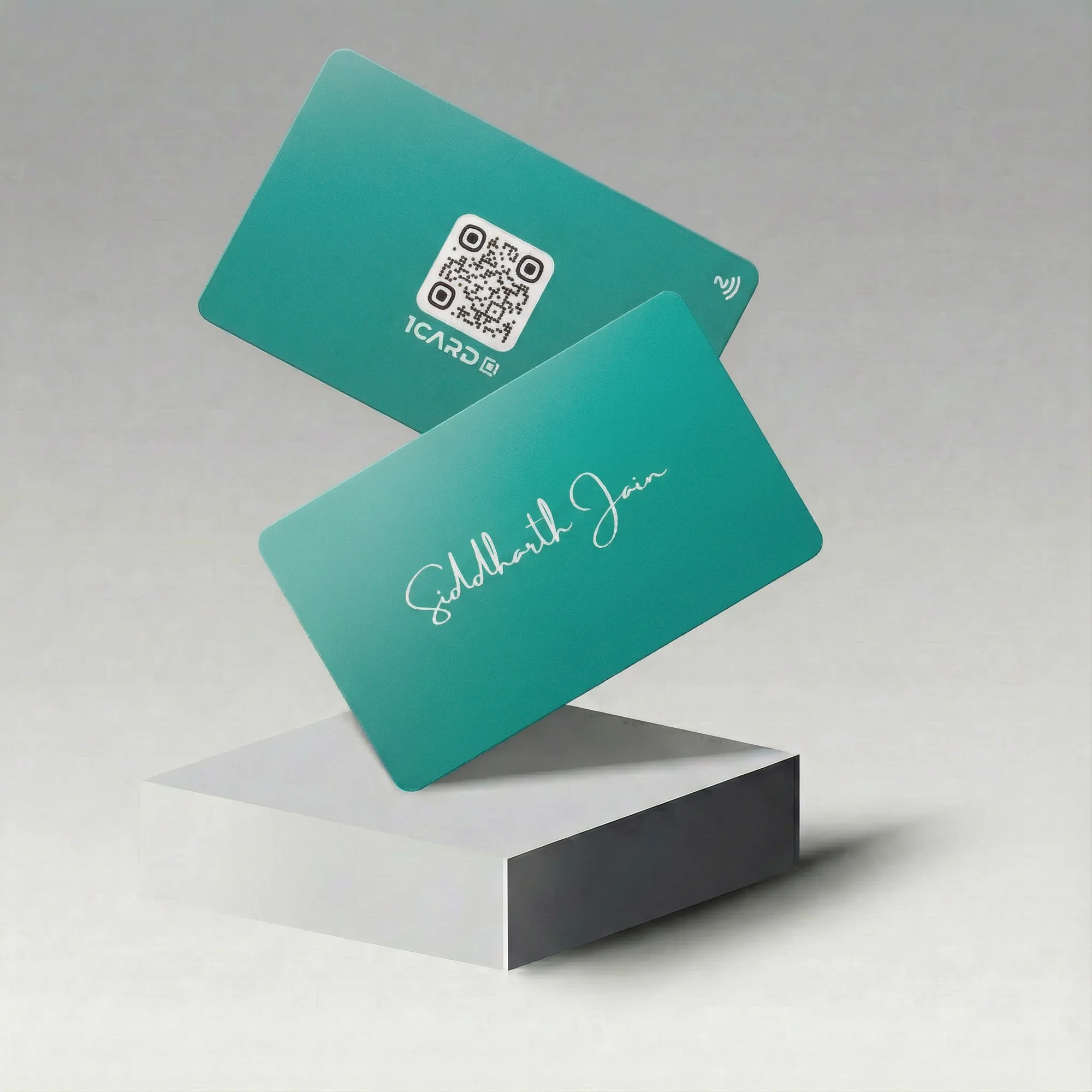 Two teal cards with a QR code and signature, floating above a white block.