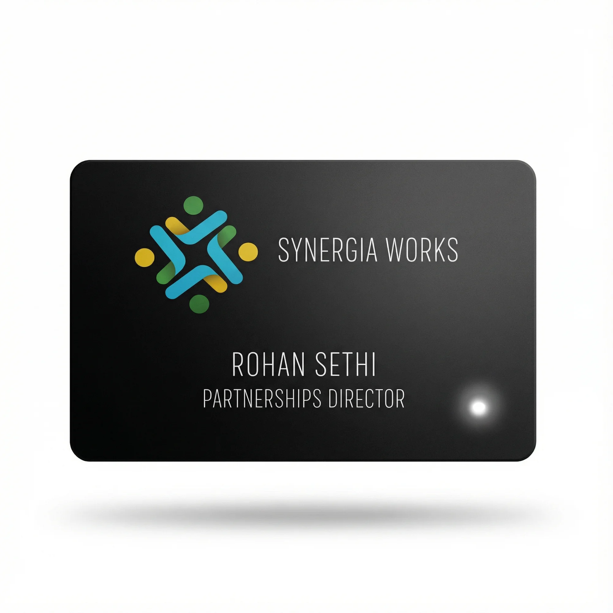 A black business card with "Synergia Works" logo, "Rohan Sethi Partnerships Director" text, and a glowing LED.