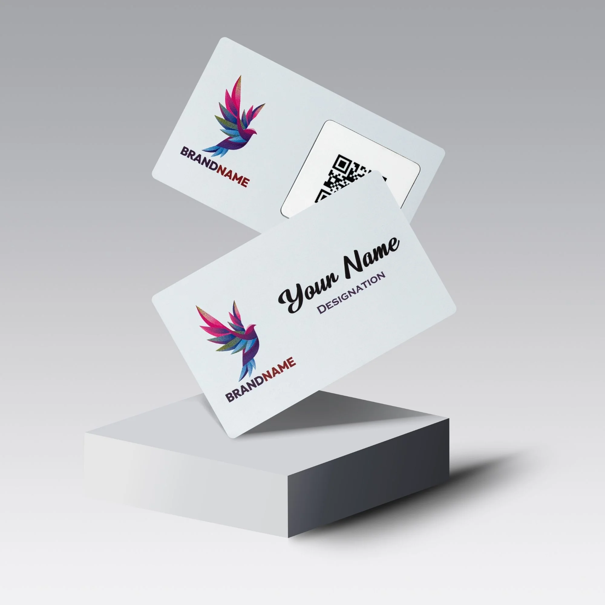Two white metal cards with colorful bird logos, one showing a QR code and the other displaying "Your Name" and "Designation.