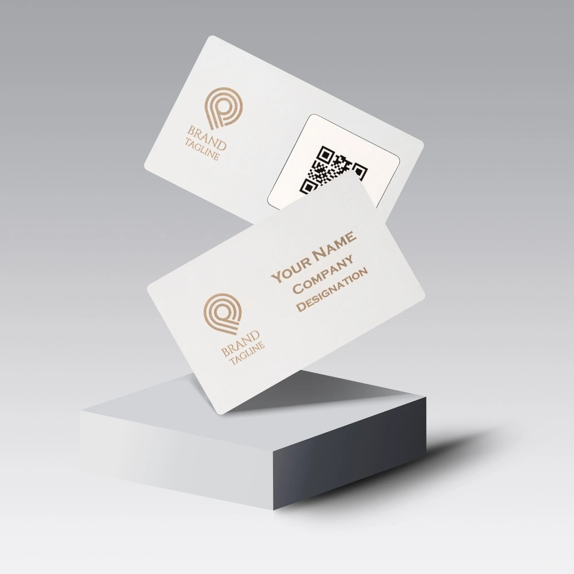 Two white metal cards with brass accents, featuring a QR code and customizable text, floating above a gray platform.