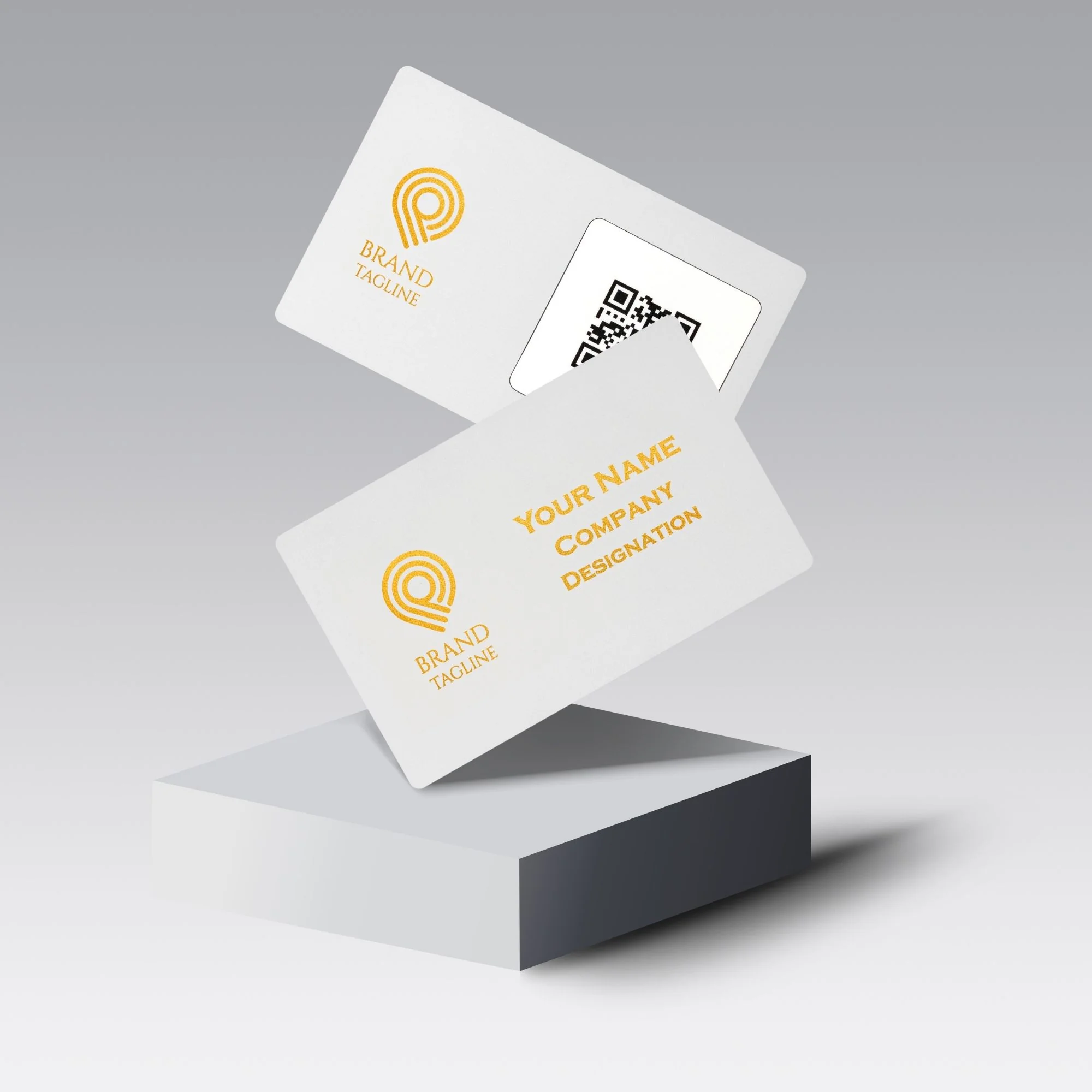 Two white cards with gold text and logos, one showing a QR code, on a gray pedestal.